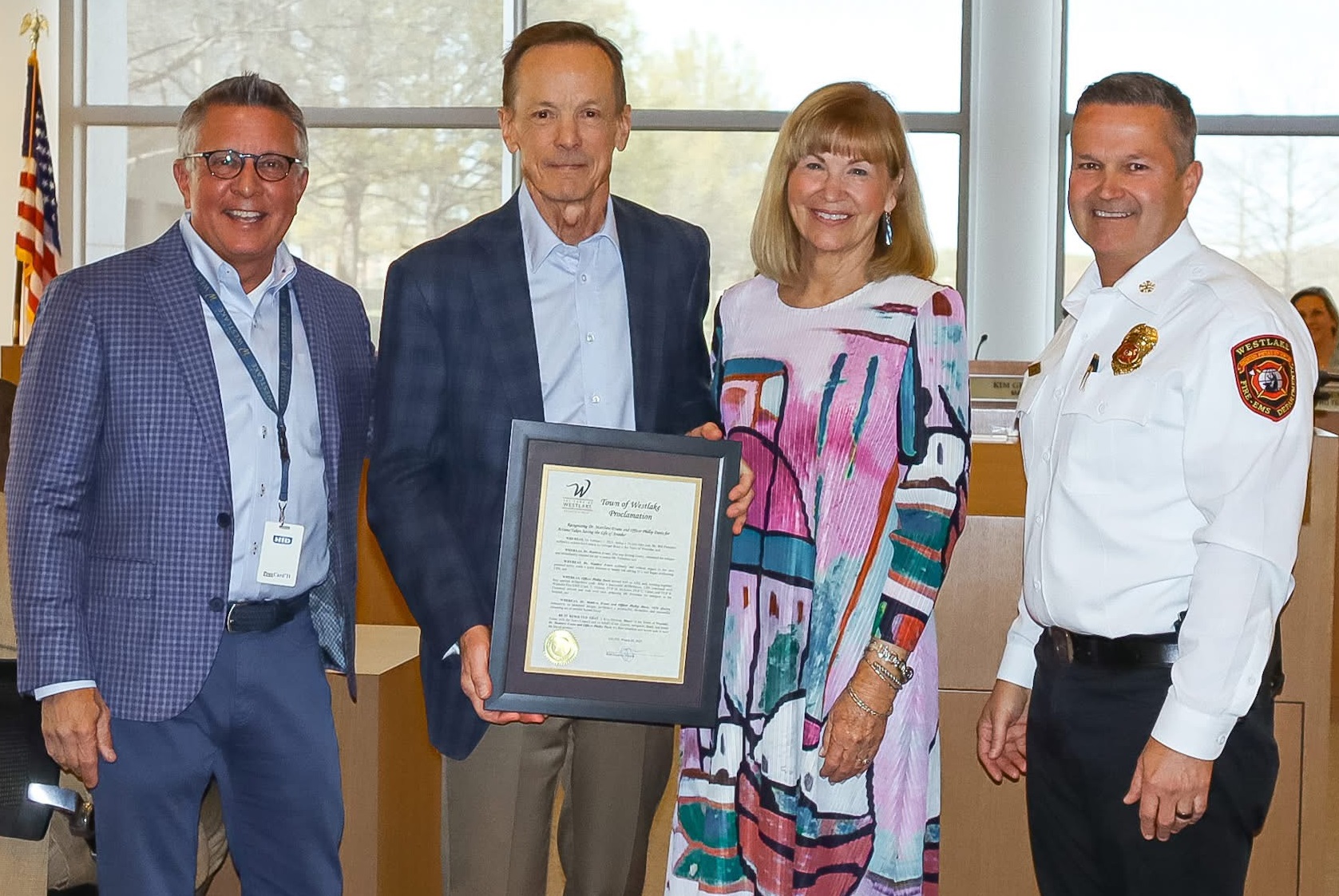 Photo of four people, including Bill Parmelee, holding a framed award.
